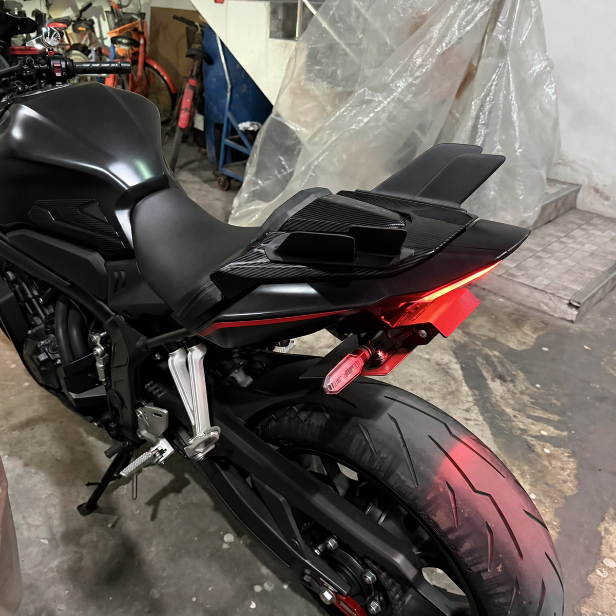 Rear winglets installed on a black CBR650R — rear three-quarter view