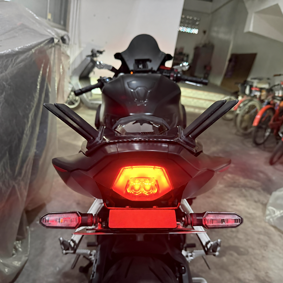 Twin-fin rear winglets installed on a black CBR650R — rear view