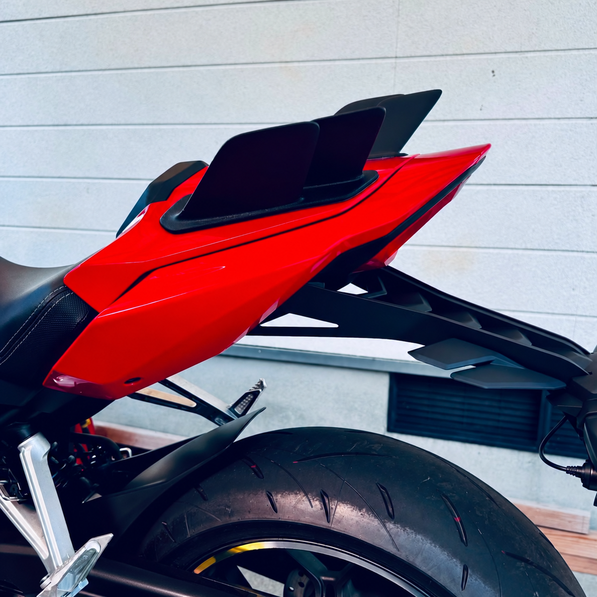 Black rear winglets installed on a red CBR650R — side view