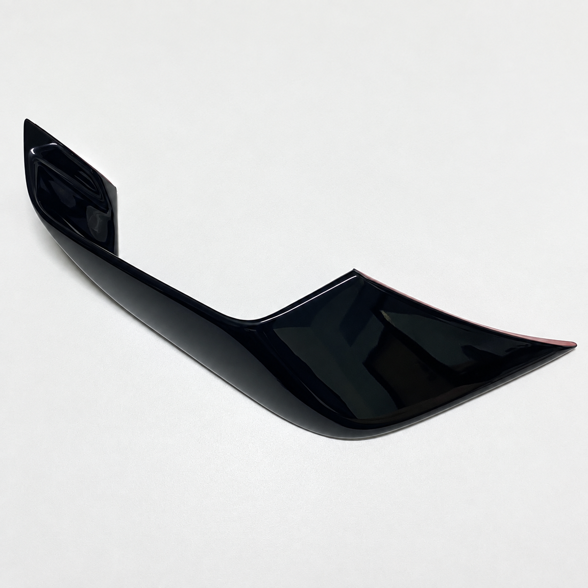 Close-up of one gloss-black YZF-R7 front winglet, showing its sculpted contour