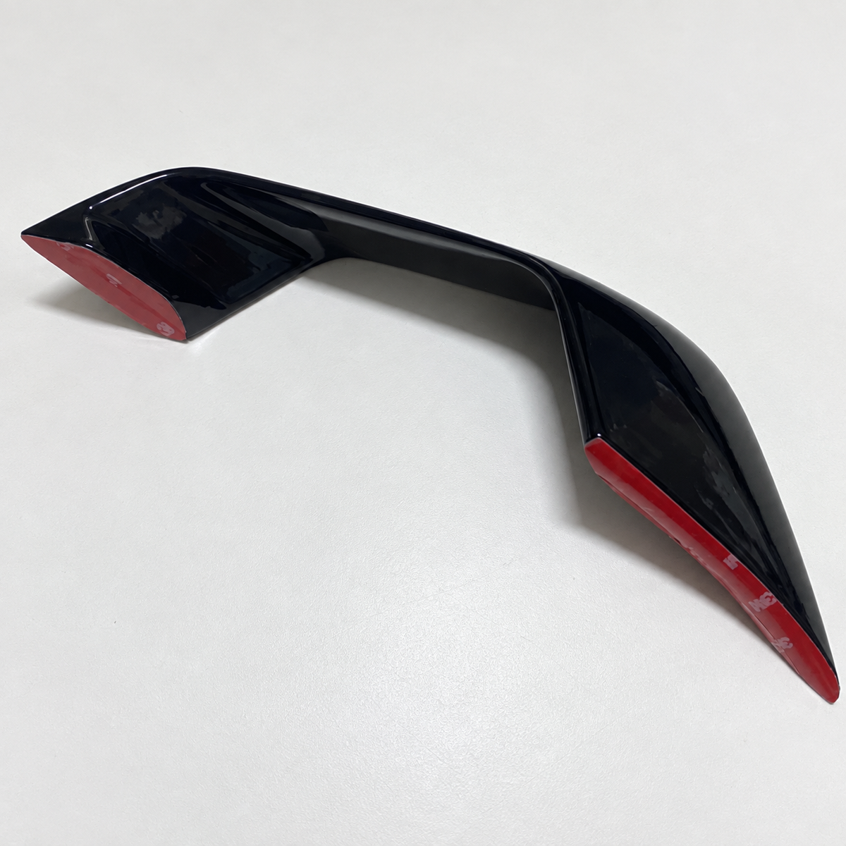 Close-up of the matching YZF-R7 front winglet and adhesive-backed mounting surface
