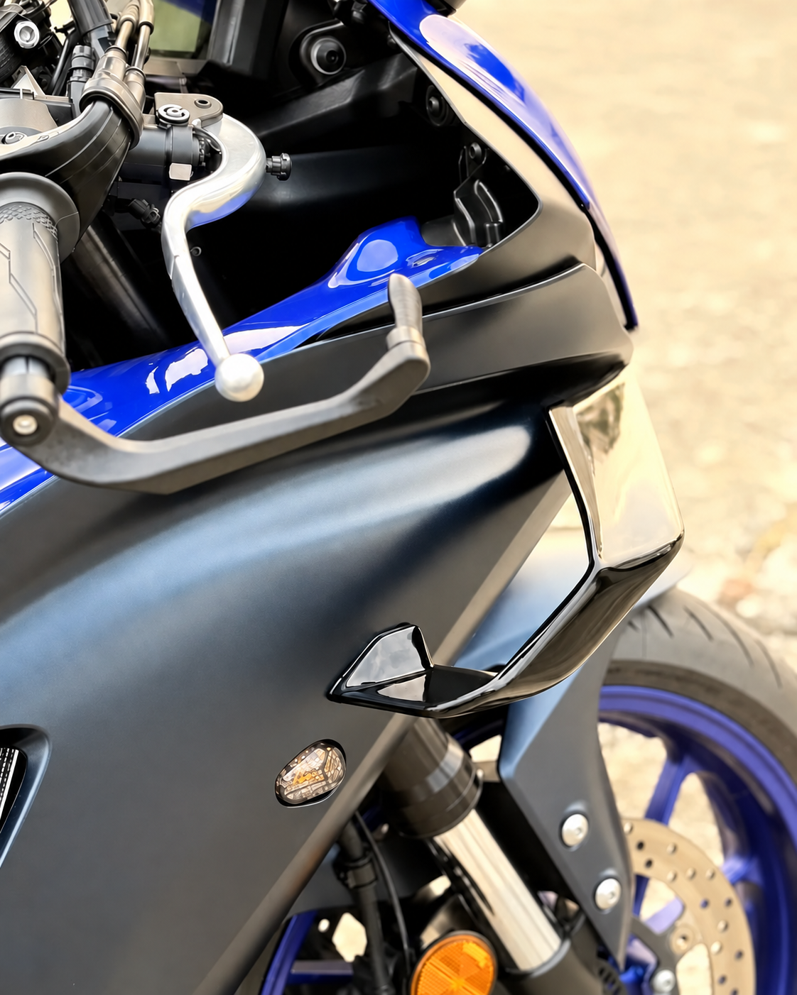 Close-up of right front winglet installed on a blue Yamaha R7